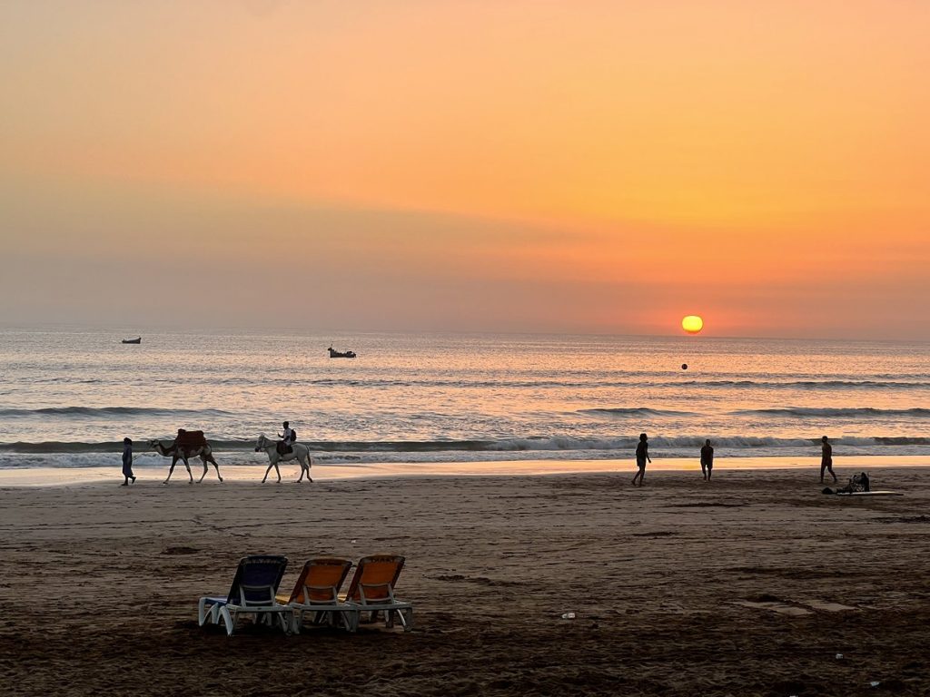 Go to the beach in Agadir, Morocco and watch the beautiful sunset into the sea